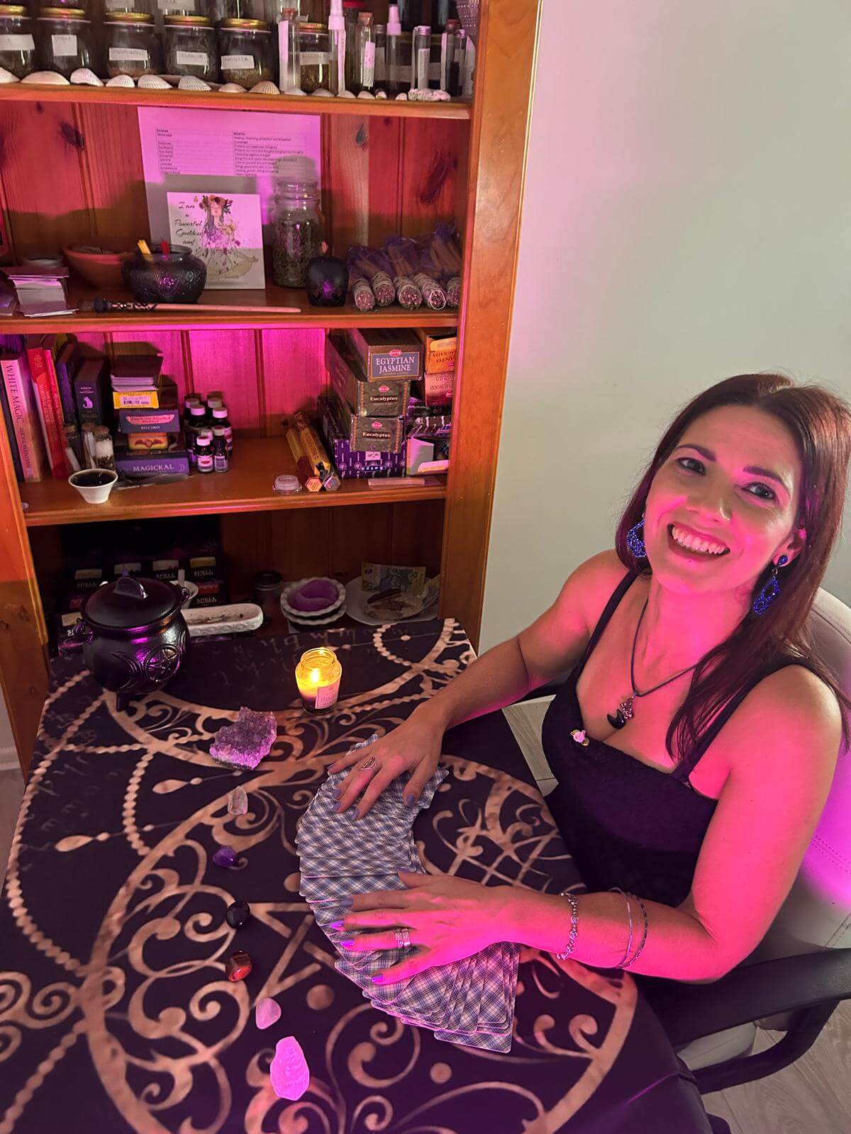 Woman performing a Tarot reading with cards on a table