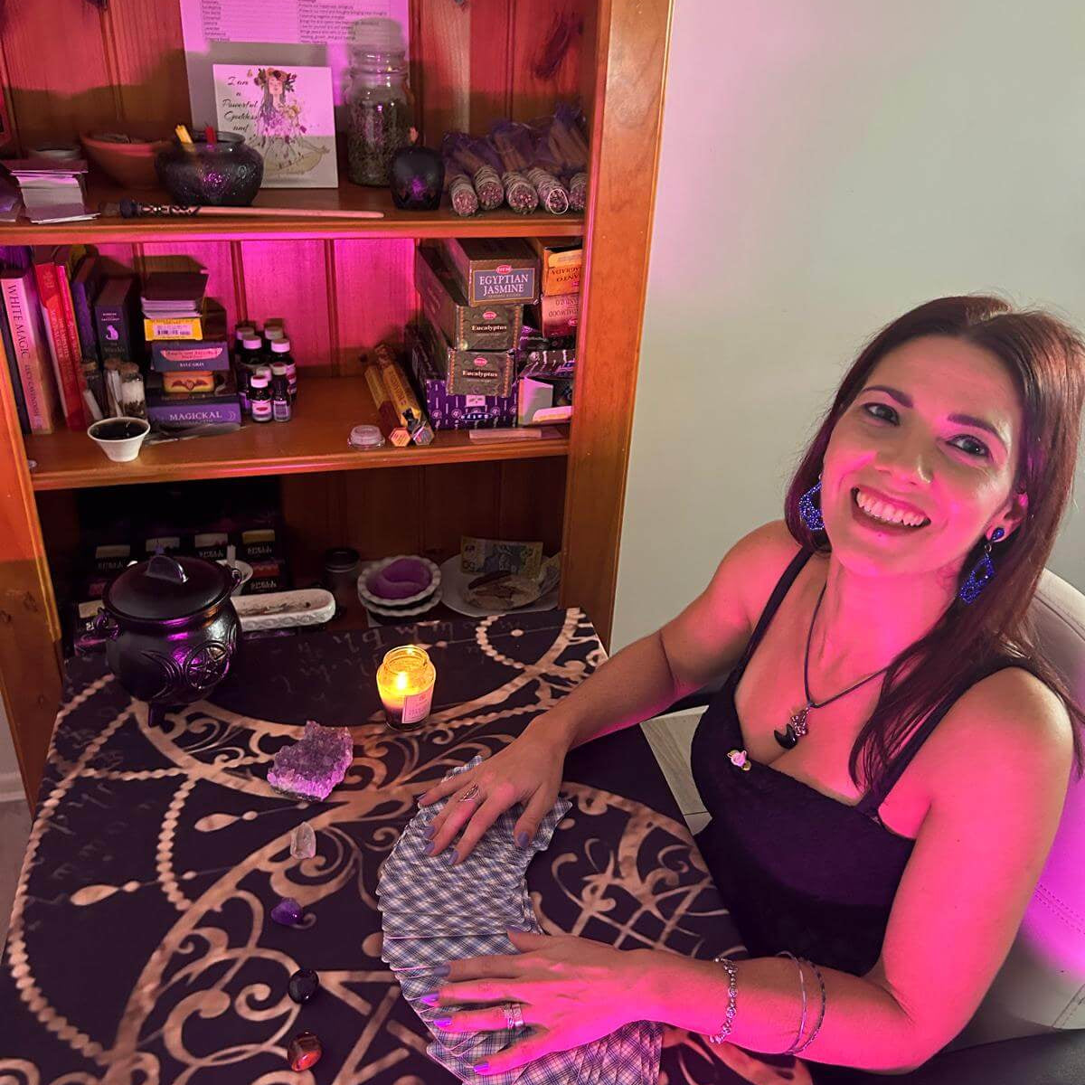Woman performing a Tarot reading with cards on a table