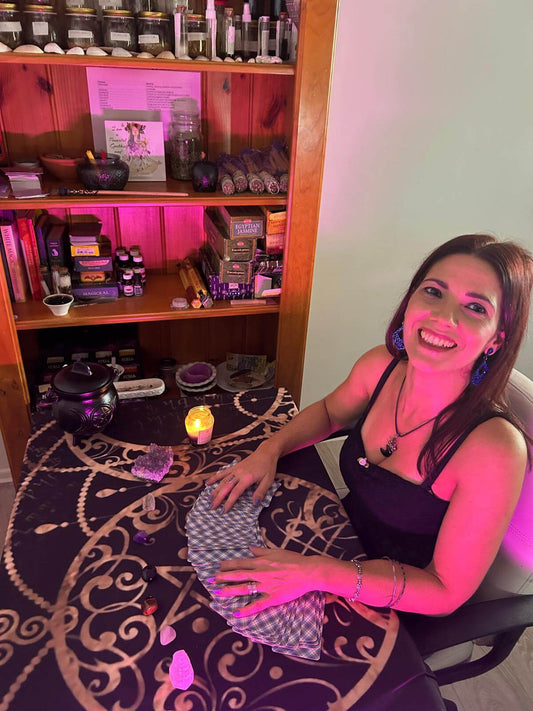 Woman performing a Tarot reading with cards on a table